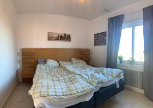 a bedroom with a bed and a window at 4 Bed Apartment with balcony in Karlskrona in Karlskrona