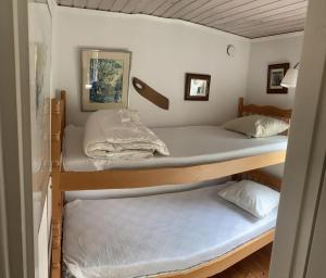 a couple of bunk beds in a room at Cozy and Private 3-Bed House with bath Roslagen in Herräng