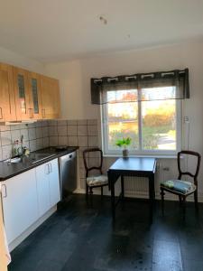 a kitchen with a table and chairs and a window at Immaculat 4 Bed Apartment in Karlskrona in Karlskrona