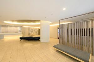 a lobby with a waiting room with a couch at Richmond Hotel Yokohama-Bashamichi in Yokohama