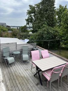 a deck with a table and chairs and a table and a table and chairs at Immaculat 4 Bed Apartment in Karlskrona in Karlskrona