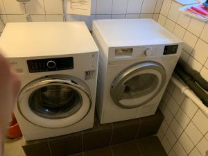 a washer and a washing machine in a bathroom at Immaculat 4 Bed Apartment in Karlskrona in Karlskrona