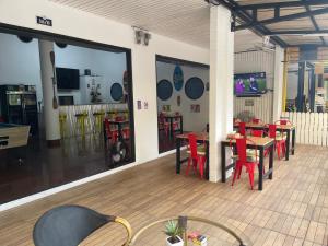 a restaurant with red chairs and tables in a room at Skipper's Karon in Karon Beach