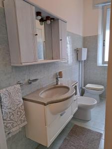 a bathroom with a sink and a toilet at Casa Gelsomino in Rimini