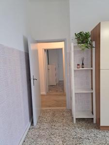 a hallway with a door open to a room at Casa Gelsomino in Rimini