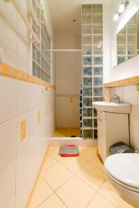 a white bathroom with a toilet and a sink at Mieszkanie Gdynia in Gdynia