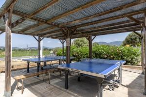 two ping pong tables under a pergola at Camping du Grand Batailler in Bormes-les-Mimosas