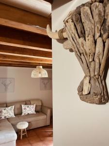 a living room with a couch and a sculpture on the wall at Casa Moline Apartamentos Rurales in Aneto