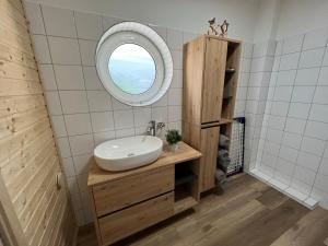 a bathroom with a sink and a mirror at Bergpanorama - Suite Willingen in Willingen