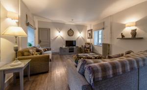 a living room with two couches and a tv at Abbaye de la Bussière in La Bussière-sur-Ouche