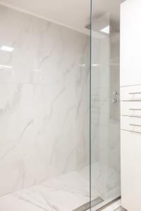 a shower with a glass door in a bathroom at Downtown supreme apartment kavala in Kavála +15 photos
