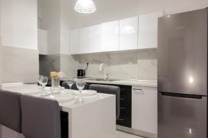 a kitchen with a table with wine glasses on it at Downtown supreme apartment kavala in Kavála