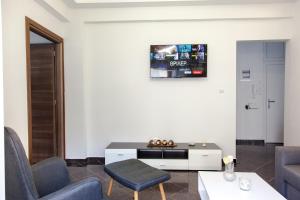 a living room with two chairs and a table at Downtown supreme apartment kavala in Kavála