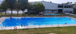 a large swimming pool in front of a building at Corazón de Mágina in Bedmar