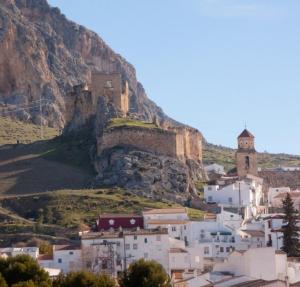 a town on a mountain with a church on it at Corazón de Mágina in Bedmar