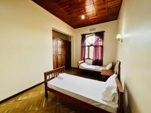 a room with two beds and a window at Mahali Muzuri, Arusha in Arusha