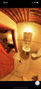 a bathroom with a sink and a toilet in a room at Monastery cave Hotel Cappadocia in Mustafapaşa