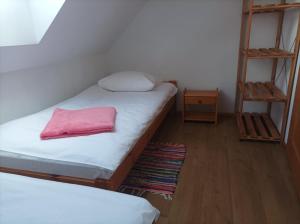 a bedroom with two bunk beds and a pink pillow at Domki Afrodyta in Jarosławiec
