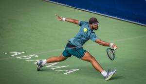 a man hitting a tennis ball with a racket at Las Terrazas de Abama Suites in Guía de Isora