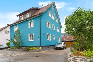 a blue house with a car parked in front of it at Völker in Haslach im Kinzigtal