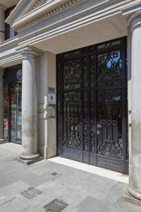 a building with a large black door with columns at The Moods Catedral Hostal Boutique in Barcelona