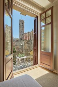 a bedroom with a window with a view of a castle at The Moods Catedral Hostal Boutique in Barcelona