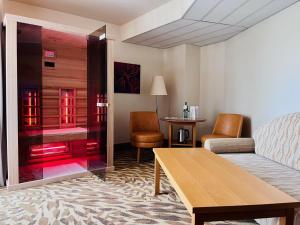 a living room with a couch and a table at Lotus Therme Hotel & Spa in Hévíz