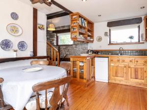 a kitchen with a table with a white table cloth on it at Cranesbill Barn in Kirkby Stephen