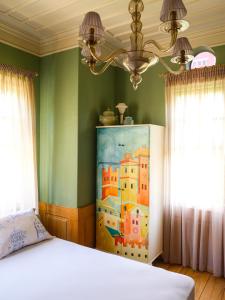 a bedroom with a bed and a painting on the wall at 3BR Venetian-style Villa in Mytilene City Centre in Mytilini