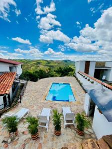 a villa with a swimming pool on a roof at Casa Luna Hotel Campestre & Spa in San Gil