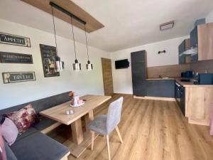 a living room with a table and a couch at Apart Alpenherz in Schwendau