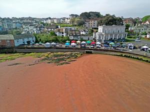 a view of a beach with umbrellas on a bridge at Sunnybeach Holiday Apartments in Paignton