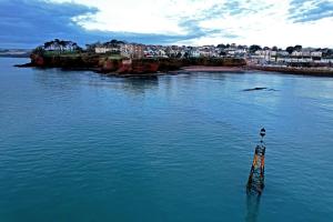 a pole in the middle of a body of water at Sunnybeach Holiday Apartments in Paignton