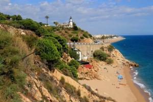 a group of people on a beach near the ocean at Playa 5 min, Terraza, AC, WiFi, Parking in Calella