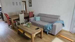 a living room with a couch and a table at Apartmány Rudlová in Banská Bystrica