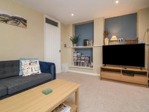 a living room with a couch and a flat screen tv at Lynmouth View in Lynmouth