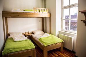 two bunk beds in a small room with a window at Hostel Mladinski center Šmartno ob Paki in Šmartno ob Paki