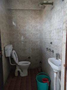 a bathroom with a toilet and a sink at Hotel Shubhadra Guest House in Mathura