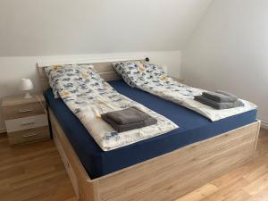 a bedroom with two beds with blue sheets at Ferienwohnung Andreea in Vlotho