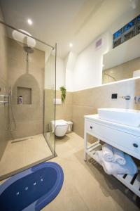 a bathroom with a sink and a toilet and a shower at Apartments PRN in Prishtinë