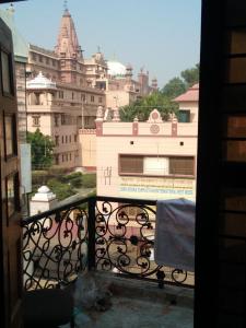 a view of a city from a balcony with a building at Hotel Shubhadra Guest House in Mathura