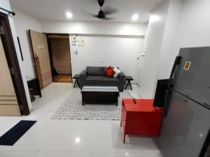 a living room with a couch and a table at Marina 203, NL Road, Bandra West by Connekt Homes in Mumbai