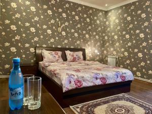 a bedroom with a bed and a bottle of water on a table at Christy Hotel in Goris