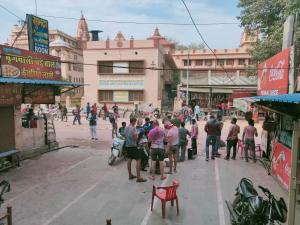 a group of people standing on a street in a city at Hotel Shubhadra Guest House in Mathura