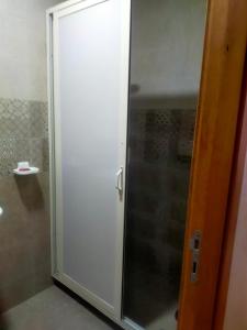 a shower stall with a glass door in a bathroom at Appt a 500 m de la plage in Douar Ourlali