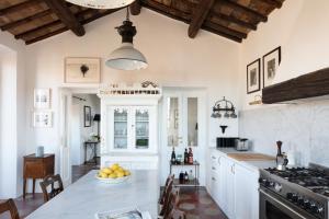 a kitchen with a table with a bowl of fruit on it at YourSuiteRome in Rome