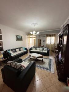 a living room with several couches and a tv at Vintage Sea-View Apartment in Centre Durres in Durrës