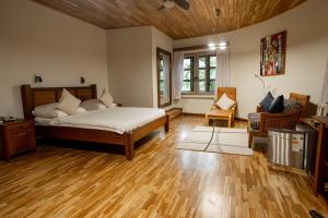 a bedroom with a bed and a wooden floor at Esther's Hotel in Accra