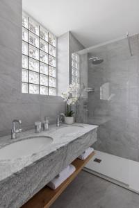 a bathroom with a large marble sink and a shower at Ascona: Nostrana Apt. 3 in Ascona