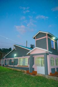 a large house with a green lawn in front of it at Entire Fully furnished Villas in Kisii in Kisii